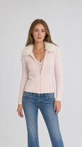 Front view of model wearing pink faux fur collar zip cardigan with jeans