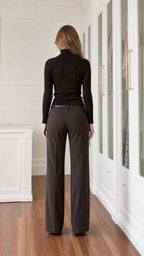 Back view of model wearing black fitted long sleeve turtleneck