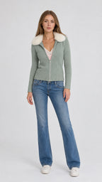 Front view of model wearing sage green faux fur collar zip cardigan with jeans